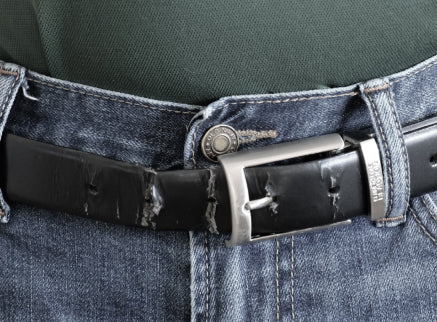 A worn out traditional leather belt with holes.