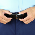 A man wearing the SureFit Belt, black side facing out, adjusting the fit.