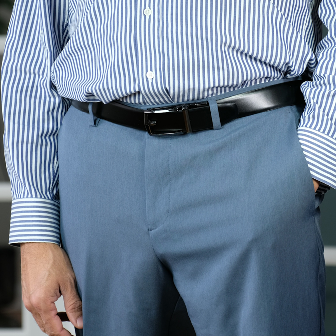 A man wearing the reversible SureFit Belt, belt without holes black side facing out.